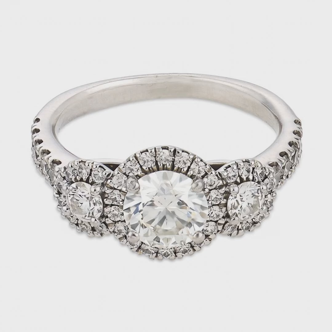 Load video: Estate 18k Three Stone Diamond Halo Ring
